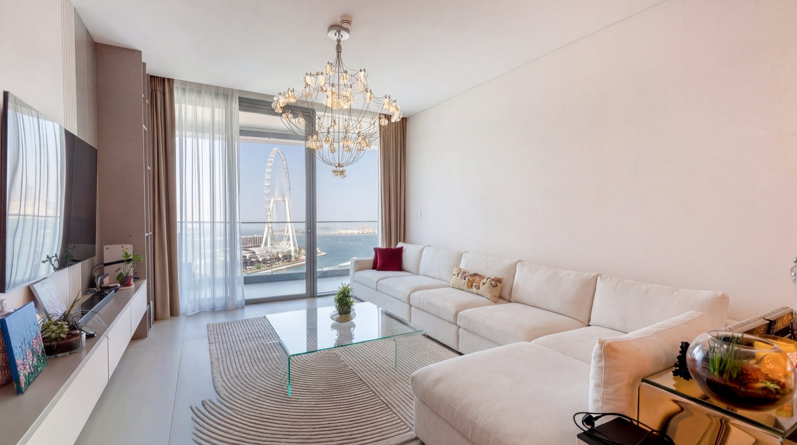 Living room with chandelier and Ain Dubai view