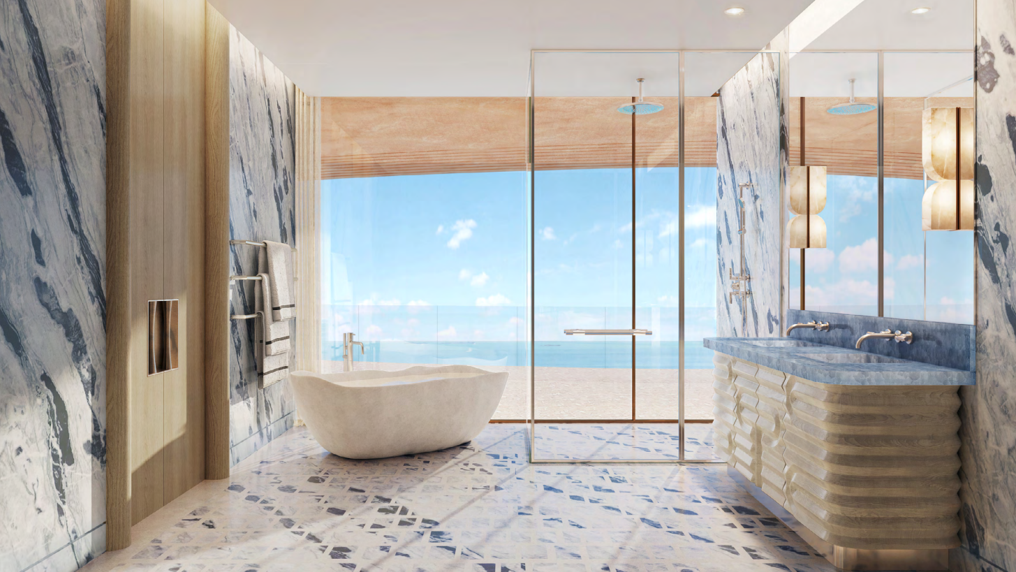 Marble bathroom with freestanding stone bathtub and sea view