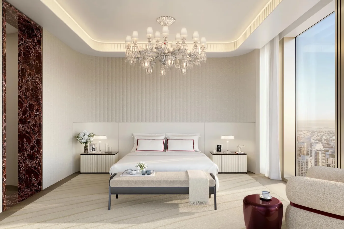 Bedroom with a crystal chandelier and marble feature column, Baccarat Residences
