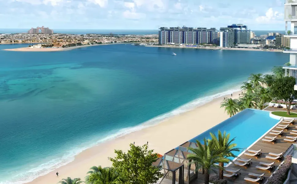 Beachfront infinity pool with sun loungers beside the private beach and Palm Jumeirah in the distance, Emaar Beachfront