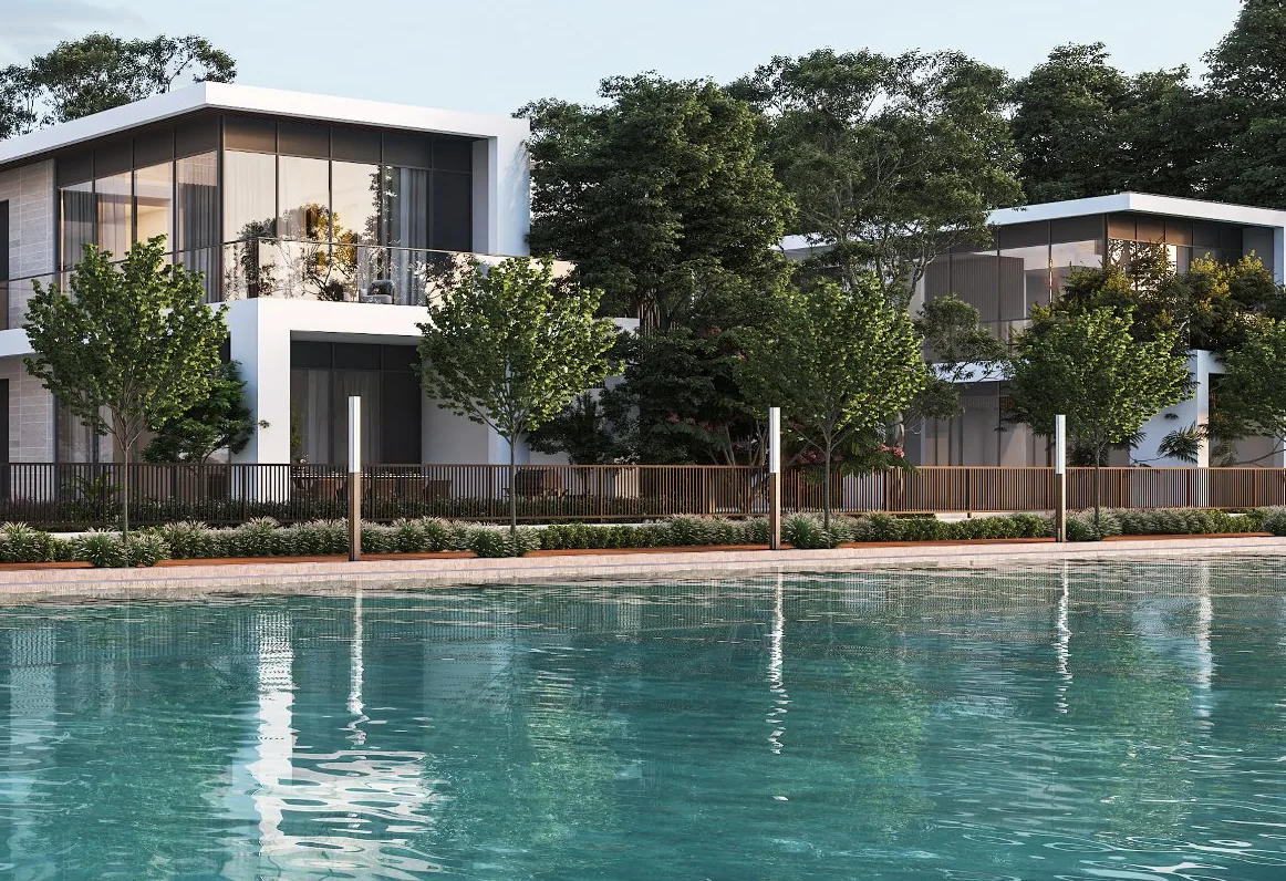 Sobha Estates villas with glass balconies and mature trees along the crystal lagoon at Sobha Hartland II
