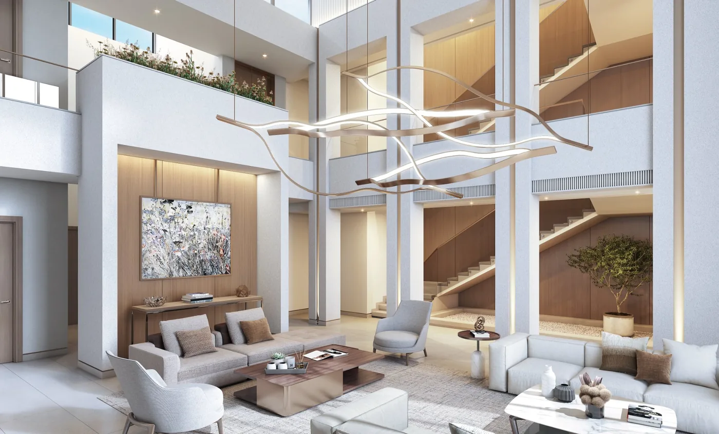 Double-height villa living room with a feature staircase and sculptural chandelier, Sobha Estates