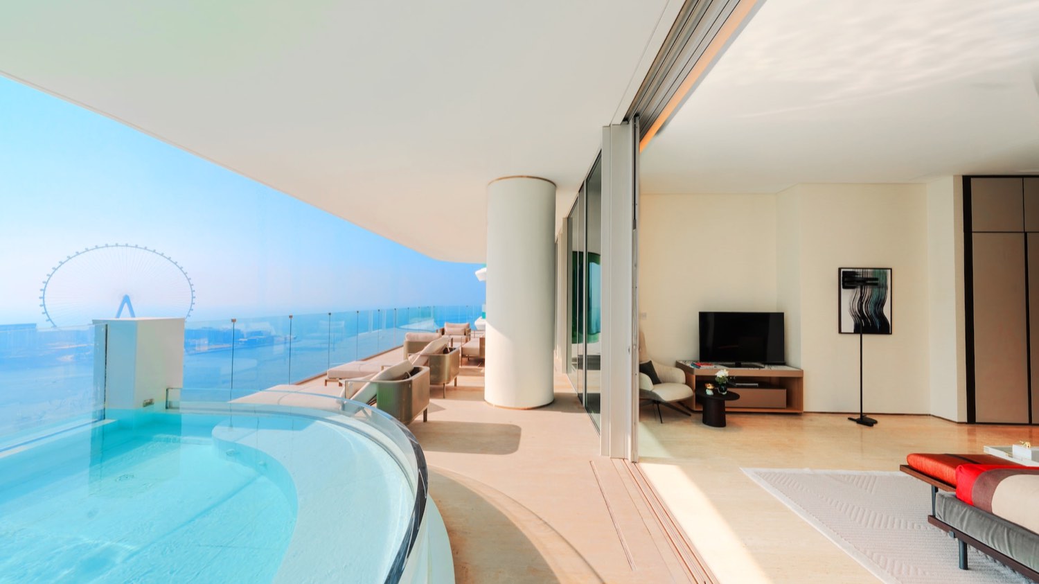Private terrace pool of a residence at FIVE LUXE JBR with a curved glass edge and a direct view of Ain Dubai and the Gulf - official FIVE Hotels and Resorts photograph